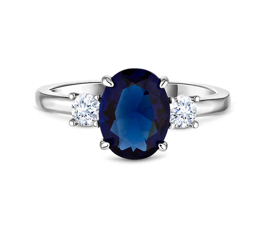 Diamond Style London - Oval cut blue ring with clear side stones in rhodi (Item code: Bluering6)