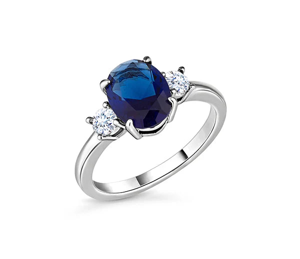 Diamond Style London - Oval cut blue ring with clear side stones in rhodi (Item code: Bluering6)